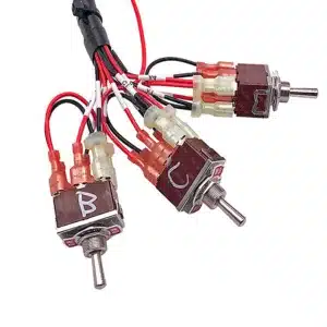 Industrial switch harness with pre-insulated quick-disconnect terminals, color-coded wiring, and ruggedized rocker switch integration.