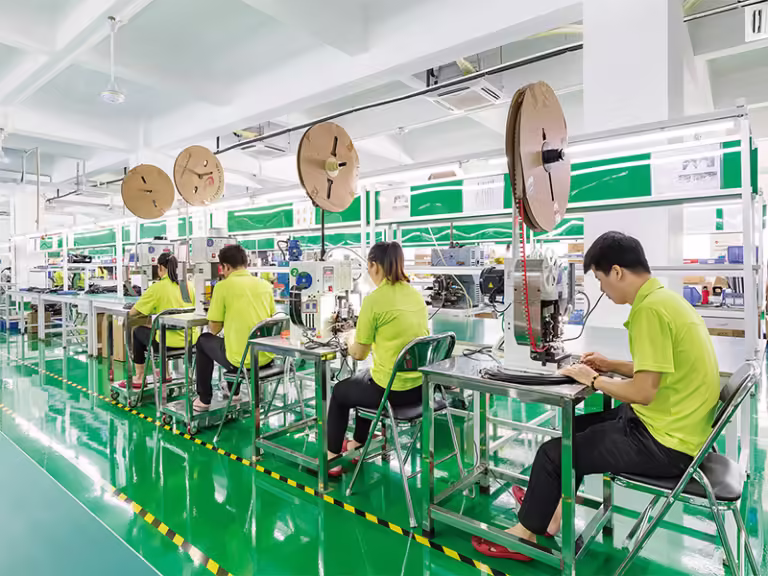 Step-by-step diagram of Romtronic's cable assembly process, including DFM, automated stripping, and 300% testing.