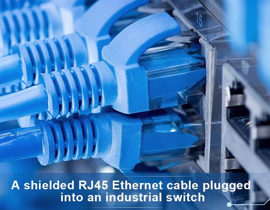 A shielded RJ45 Ethernet cable (blue) plugged into an industrial switch