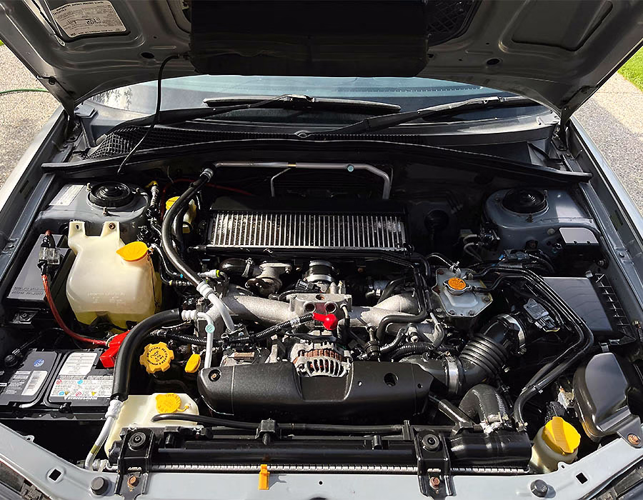 Under-the-hood view showing engine wiring and battery connections