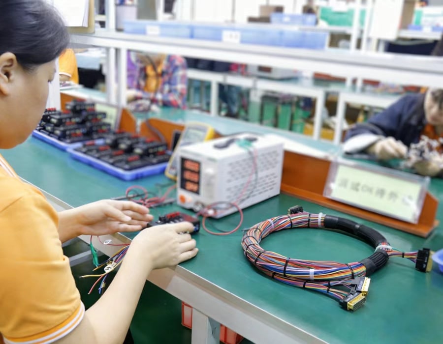 Close-up of organized high-density multi-conductor wire harness with precise termination